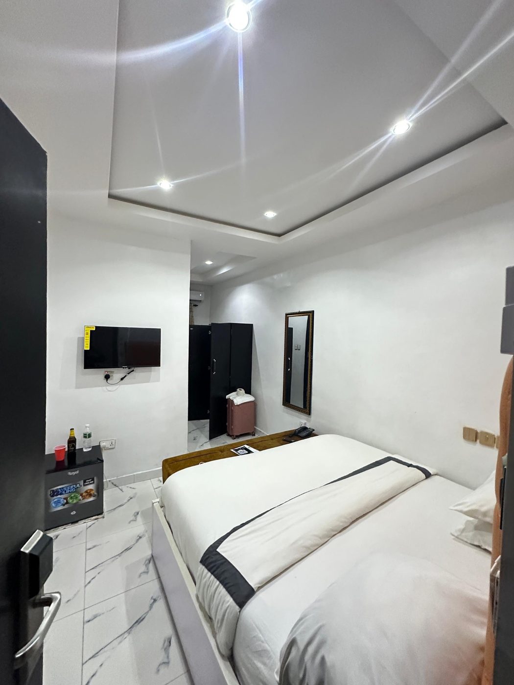 Modern room with flat-screen TV, mini fridge and wardrobe
