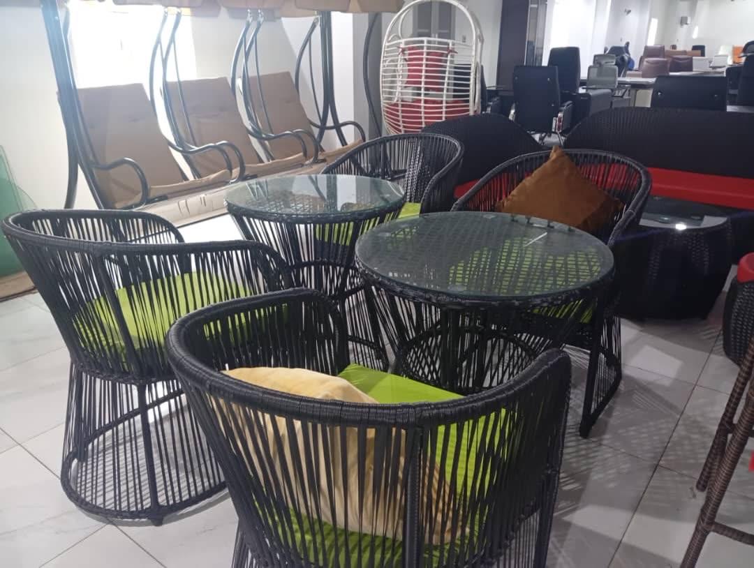 Outdoor lounge seating with woven chairs and glass tables