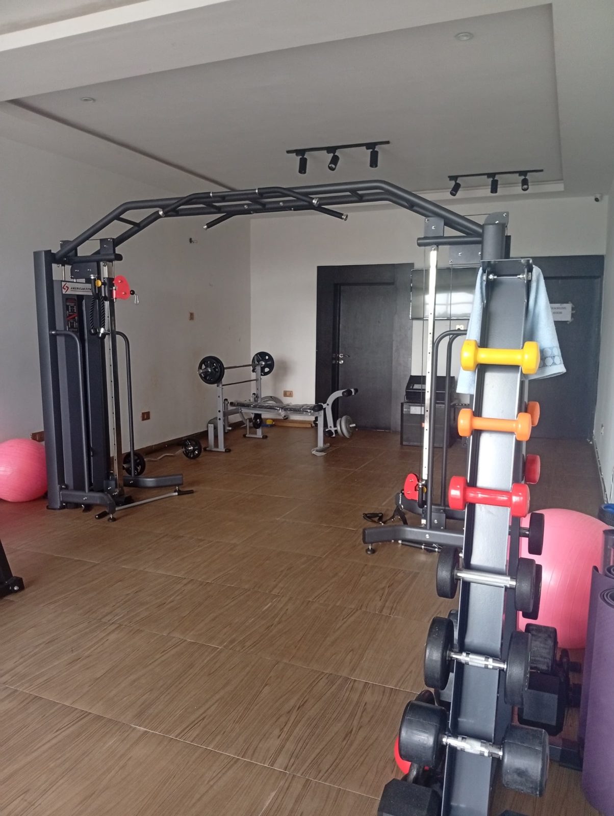 On-site fitness centre with weights and gym equipment